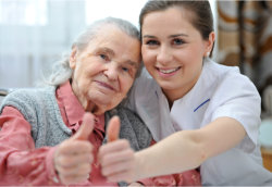 senior and nurse thumbs up