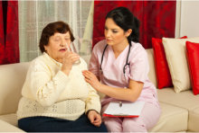 woman drinking water besides nurse